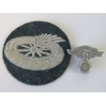 A WWII German NSKK cap badge and cloth i