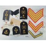 Ten sample pattern cloth badges having Q