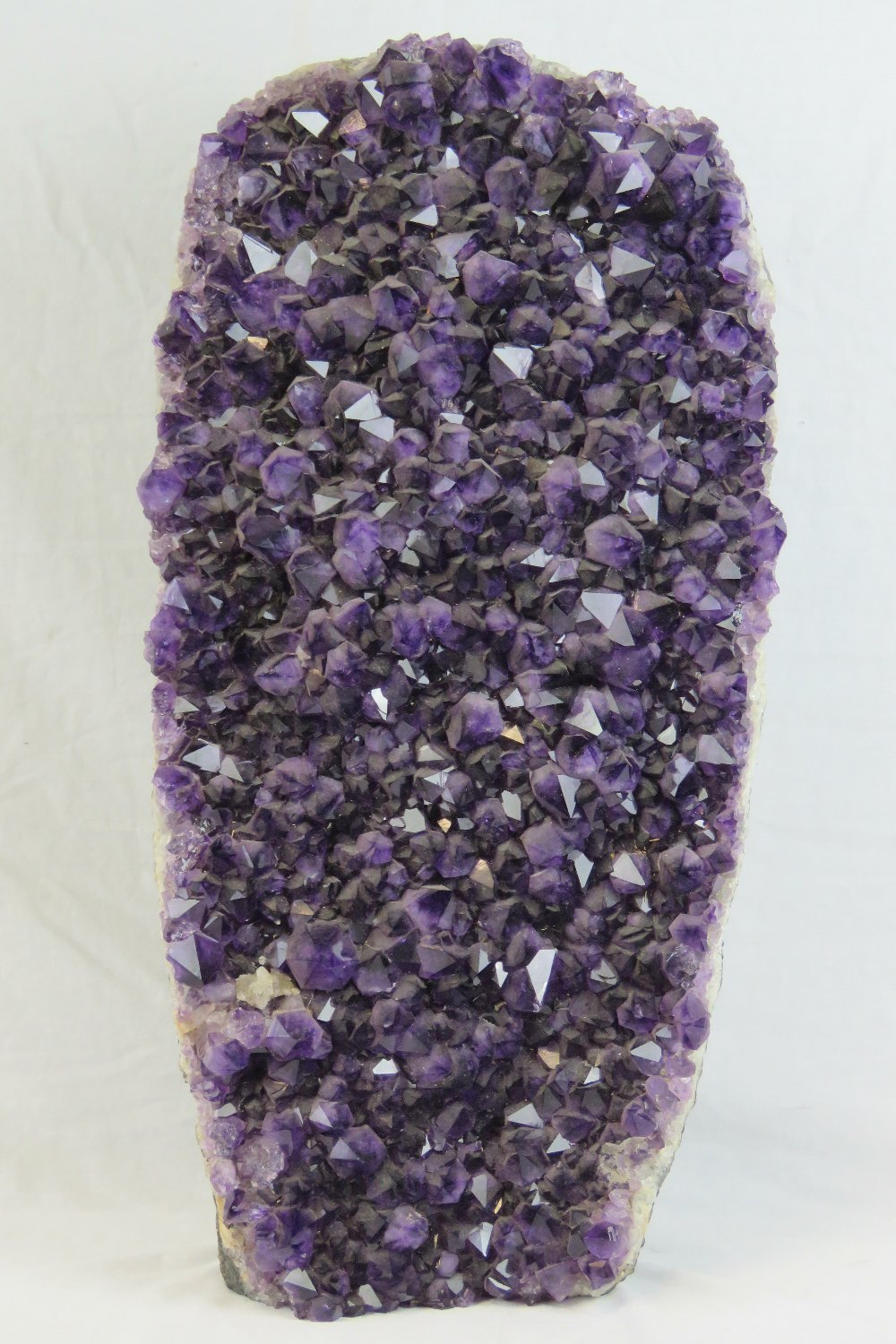 A large heavy and impressive natural amethyst geode measuring 70 x 36cm.