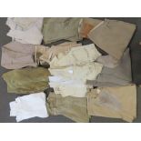 An assortment of quality vintage jodhpurs and breeches and a leather waistcoat, twelve items.