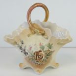 A Continental hand painted and gilded fluted basket having muted colours and bearing the backstamp