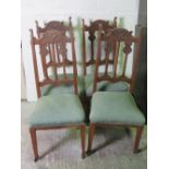 Four carved oversprung dining chairs.