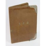 A vintage leather wallet having HM silver corner bracing, 14.5 x 10.5cm.