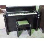 An Eavestaff Art Deco minipiano in black with chrome detailing, six octave keyboard,