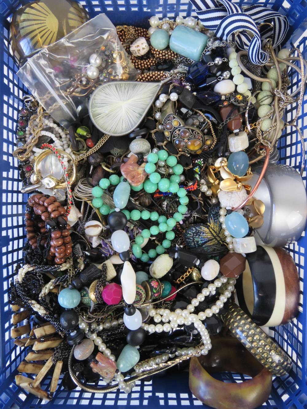 A large quantity of assorted modern and vintage costume jewellery including necklaces, bangles,