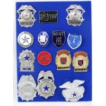 Fourteen contemporary US security badges mounted on display board.