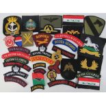 Thirty-five assorted cloth badges including; Australian, West Yorkshire, Suffolk Regiment,