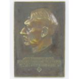 A German WWII bronze plaque cast in relief with side profile portrait of Adolf Hitler and inscribed