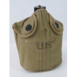 A WWII US Army water bottle with canvas cover, dated 1944.