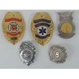 Five US Fire Department badges including; Volunteer, Emergency Medical Technician, etc.