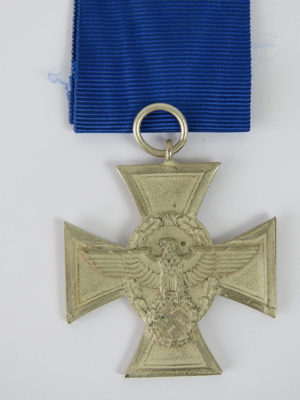 A WWII German Police medal with blue ribbon in presentation box.