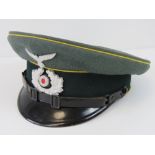 A German army NCO peaked cap, a rare example having yellow piping for the Elite Cavalry troops.