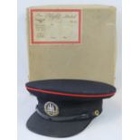 A Northamptonshire Regiment Officers peaked cap with red piping and Gibraltar cap badge, size 7 1/4,