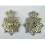 Two embossed silvered regimental shako helmet plates each with crown over and being for the