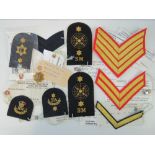 Ten sample pattern cloth badges having Quality and Product Support Division comment tags upon.