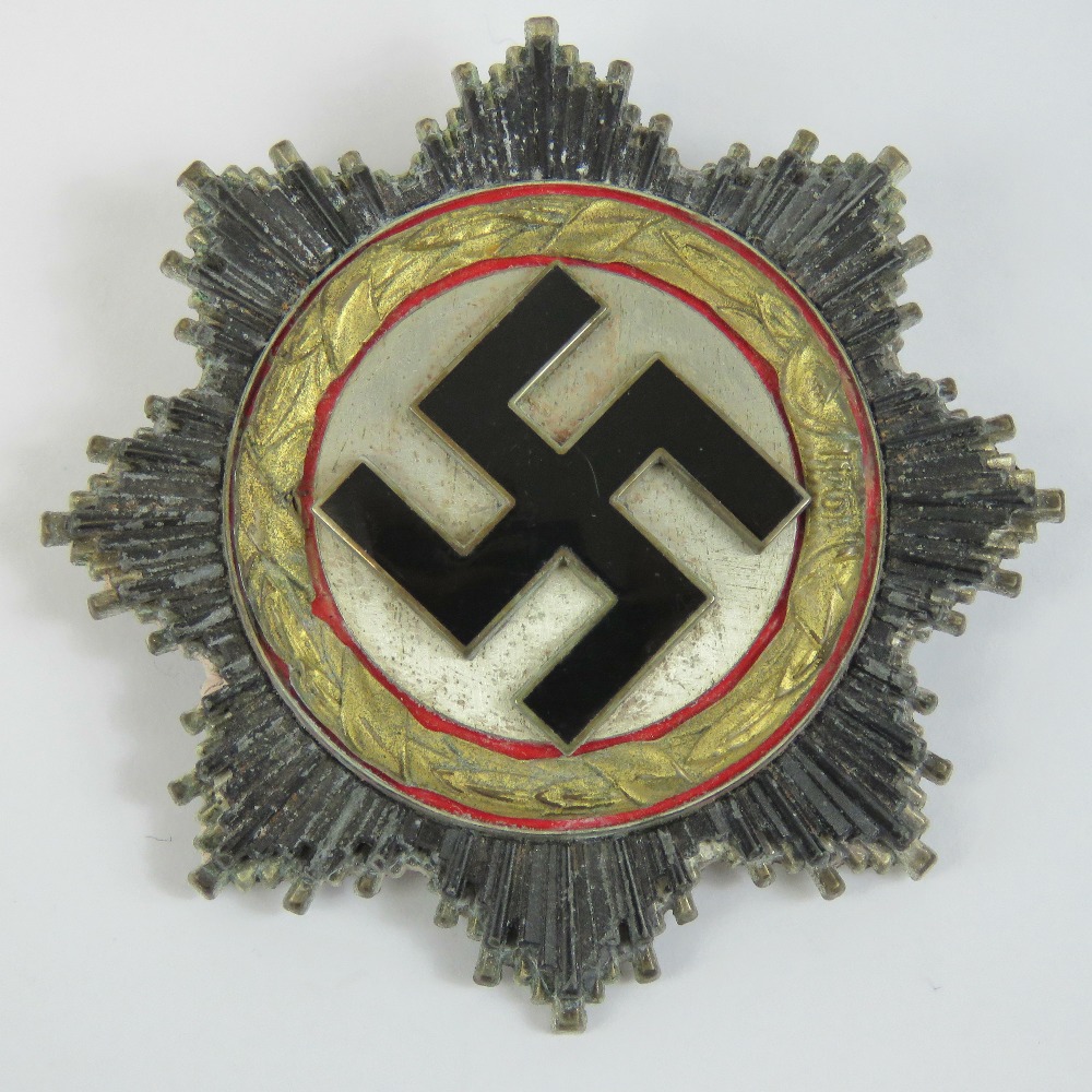 A reproduction WWII German Cross 'Gold' badge marked '1' to pin.
