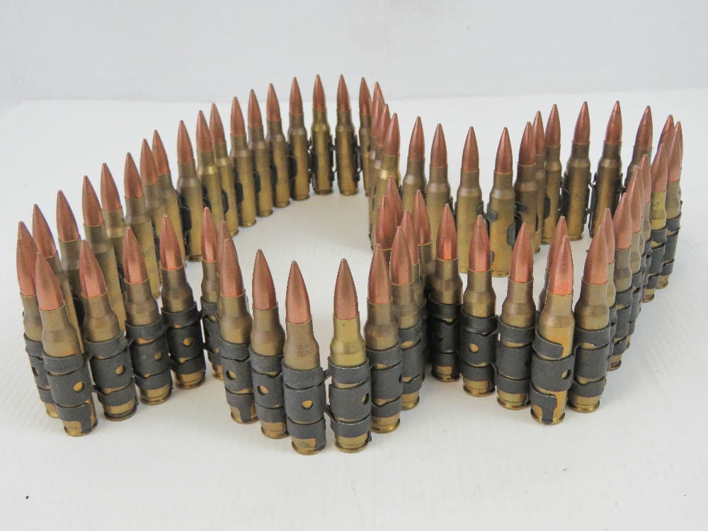 A belt of sixty-five 7.62mm inert British rounds of ammunition.