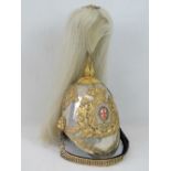A fine Victorian Household Cavalry Officers helmet having gilt brass applied decoration throughout,