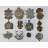 A quantity of large size military cap badges including; Argyll and Sutherland,