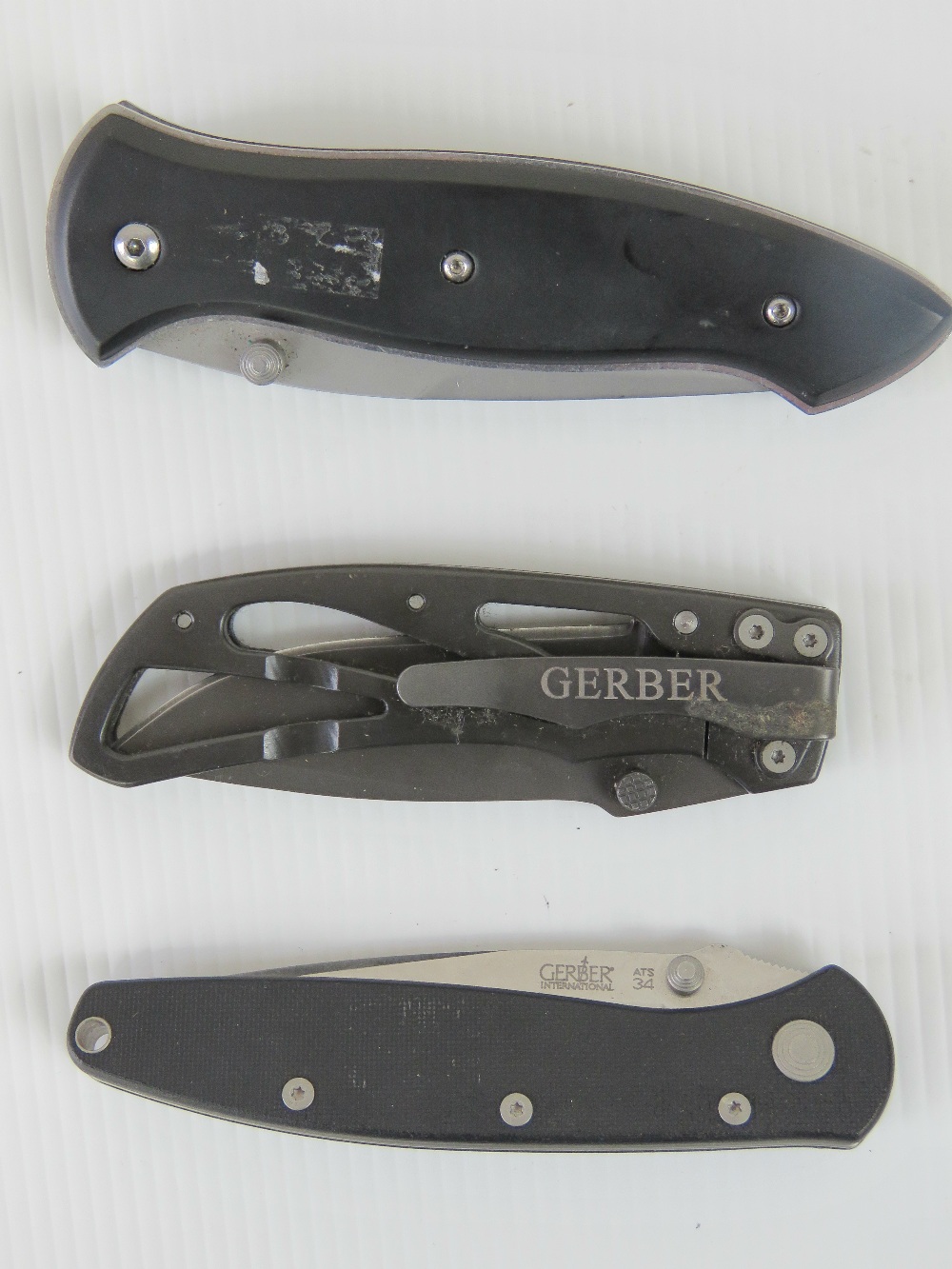 Two Gerber folding knives, together with