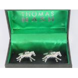 A pair of white metal cufflinks in the form of race horses with jockey upon,