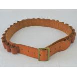 A vintage hand sewn leather 12 gauge cartridge belt having brass buckle.