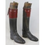 A pair of vintage gentleman's black and tan leather riding boots,