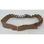 A vintage leather 12 gauge cartridge belt having brass buckle.