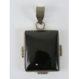 A rectangular onyx cabachon in silver pe