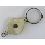 A vintage folding magnifying glass havin