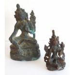 Two small bronzed brass Indian deity figurines, each in seated position,