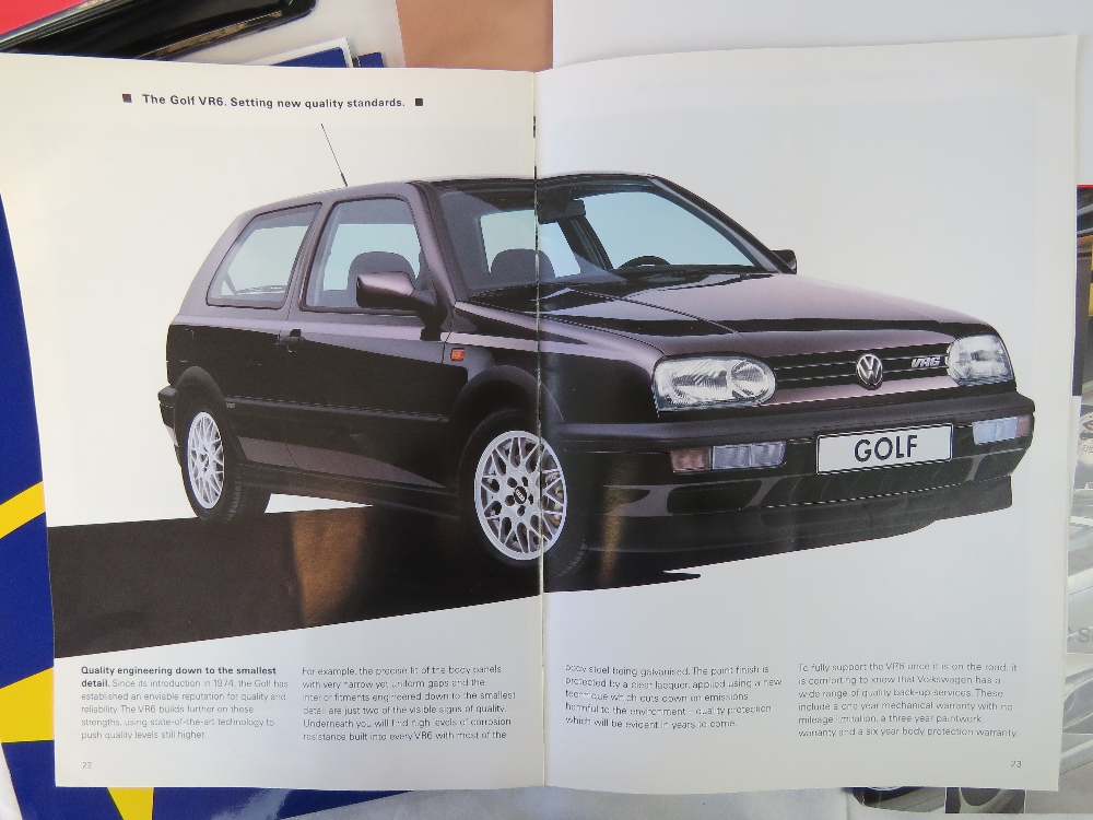 A collection of Renault, VW, Honda, BMW, Ford and Subaru advertising pamphlets,