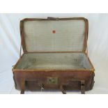 A vintage large leather suitcase with carrying handles, 87cm.