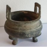 A small Chinese late 19th early 20th century bronzed brass censer having two cast handles and