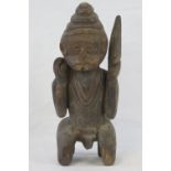 An antique carved wooden fertility figur