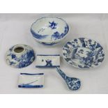 A Chinese blue and white dish, hand painted with seated figures amid flowering shrubs,