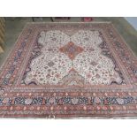 A superb woollen and silk square shaped geometric carpet in cream ground with blue and orange