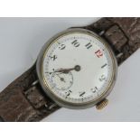 A WWI military trench watch having enamelled dial with Arabic numerals and subsidiary seconds dial