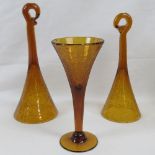 An amber Art Glass wine glass together with a pair of baseless glasses. Three items.