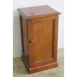 An Edwardian mahogany pot cupboard, door opening to reveal drawer and compartments within,