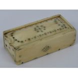 A 19th century carved ivory and bone slide top box of rivet construction having enamel decoration