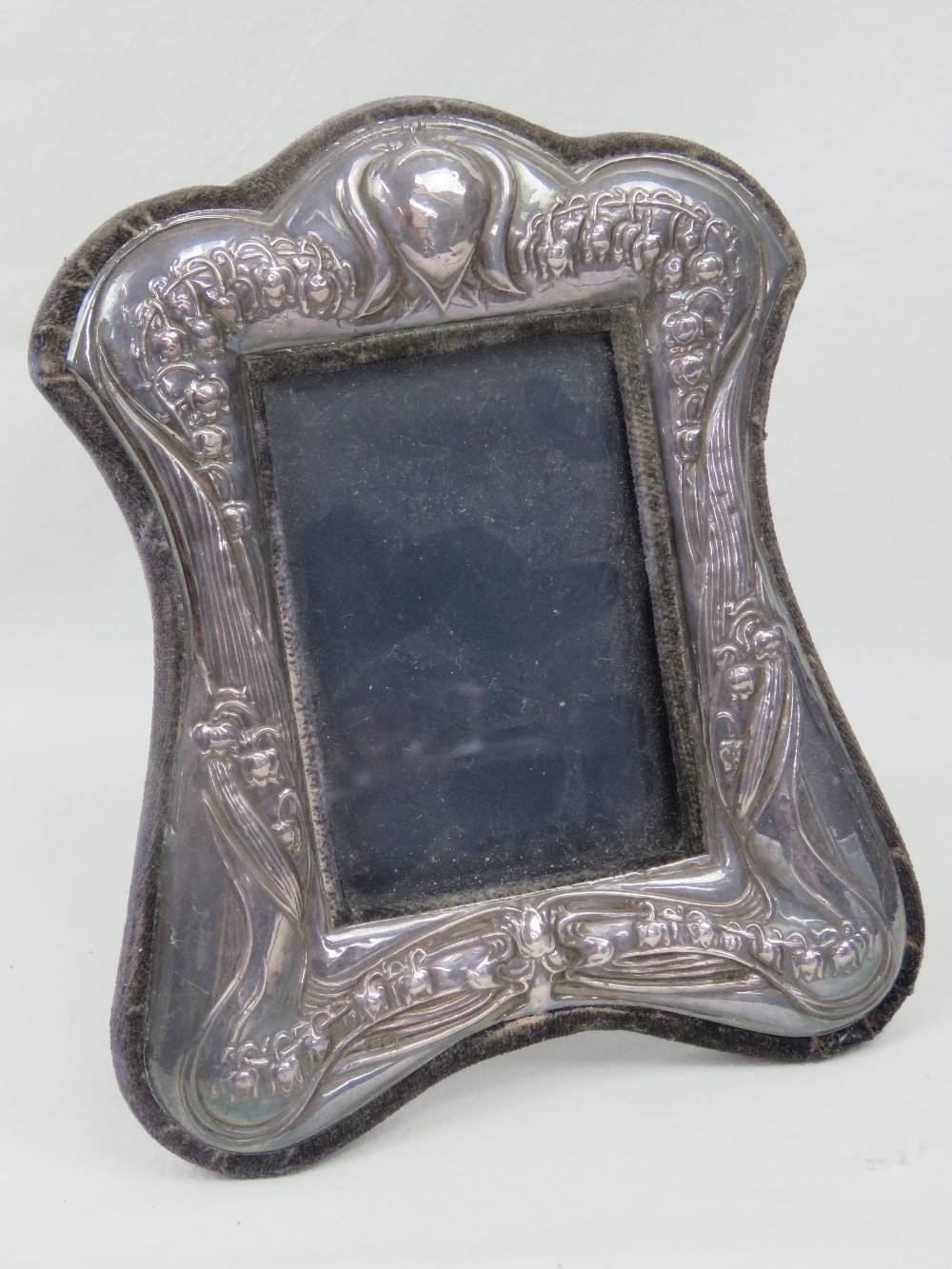 A HM silver photograph frame having repoussé bluebell design in the Art Nouveau style,
