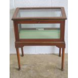 A delightful Edwardian glass and mahogany bijouterie table having satin lined base and single glass