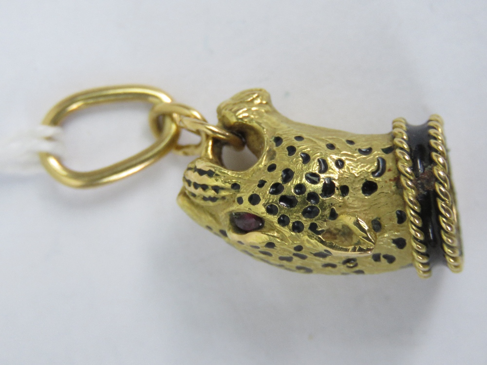 An 18ct gold pendant in the form of a leopards head having black enamel spots, enamelled collar and