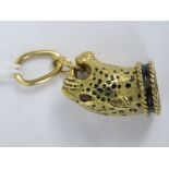 An 18ct gold pendant in the form of a leopards head having black enamel spots, enamelled collar and