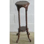 A contemporary mahogany four legged torchere or planter stand, raised over barley twist supports,