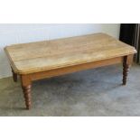 A large low rustic oak plank top coffee table raised over turned legs, 155 x 90cm.