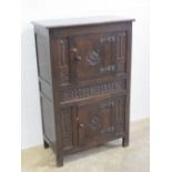 An old charm style flat fronted double door court cupboard, part carved in the Gothic revival style,