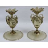 A pair of delicate glass table decorations part gilded, each having three handles with birds upon,