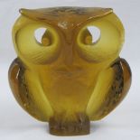 A heavy amber Art Glass owl paperweight, signed indistinctly verso, standing 12cm high.